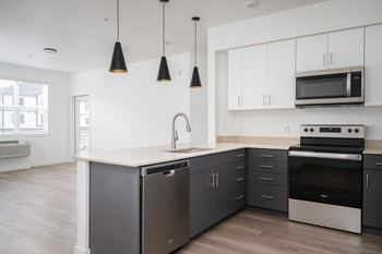 Pendant lights over peninsulas and islands in select homes